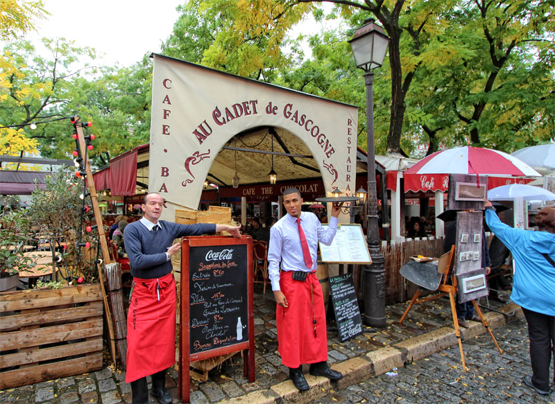 Waiters with red aprons at a Paris restaurant
