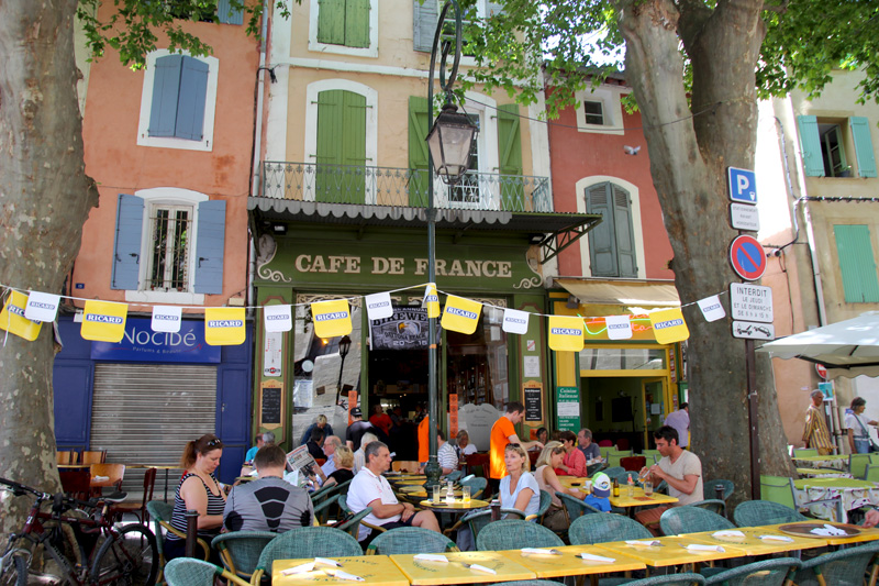 People sitting at a terraced cafe in France